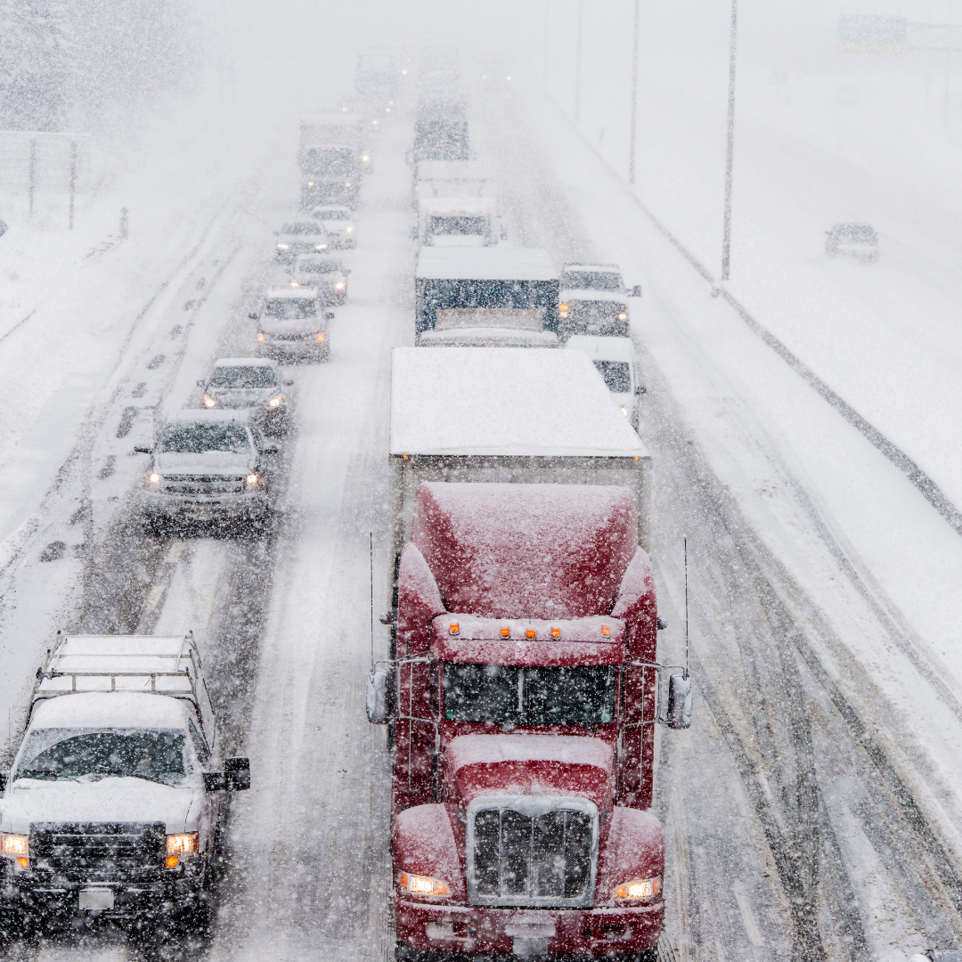 A semi-truck driving on wintery roads